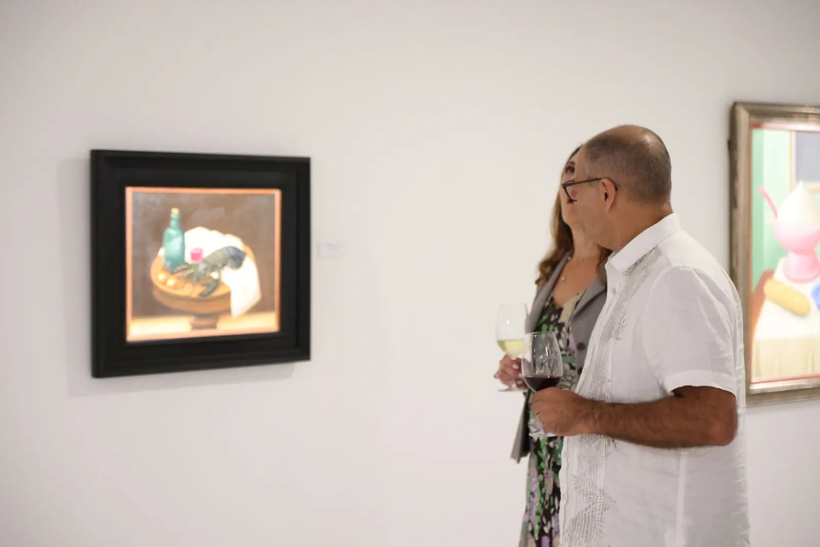 Visitors looking at a Fernando Botero still life at Gary Nader Art Centre.
