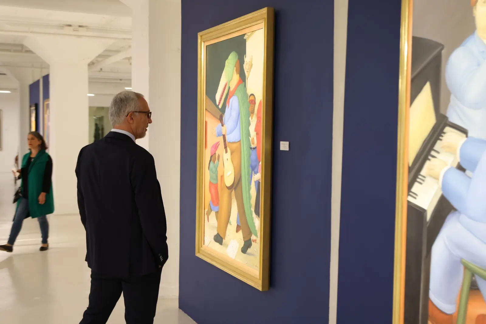 A visitor studying a Fernando Botero painting at Gary Nader Art Centre.