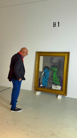 Gary Nader looking at The Two Children in its frame before installation.