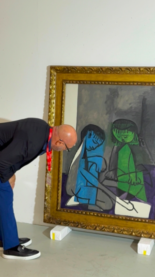 Gary Nader examining The Two Children at close range.