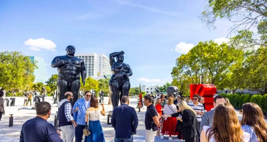 Visitors among monumental sculptures at the opening of Nader Sculpture Park in Miami Design District.