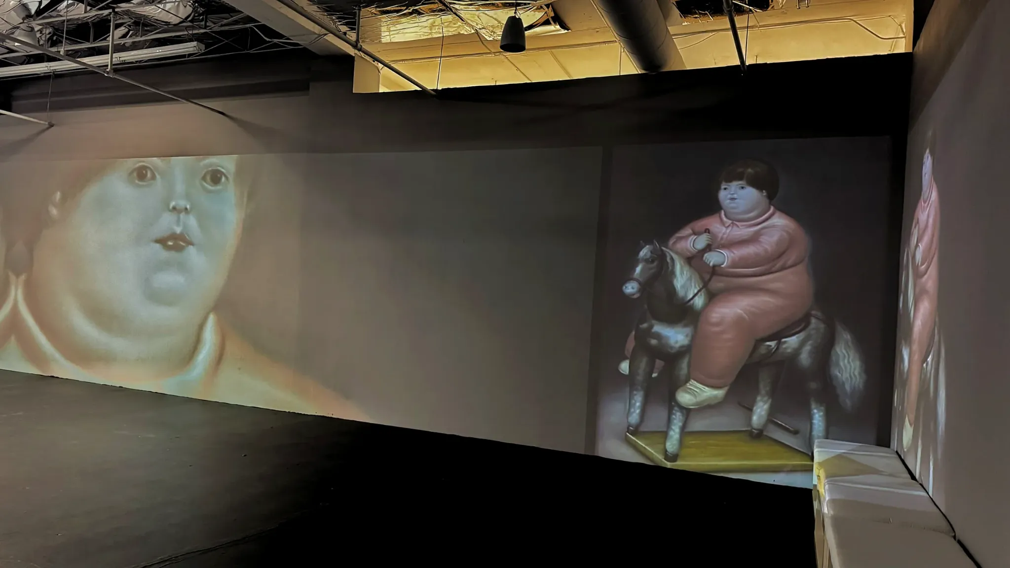 Fernando Botero’s imagery of a child on a toy horse in the immersive installation
